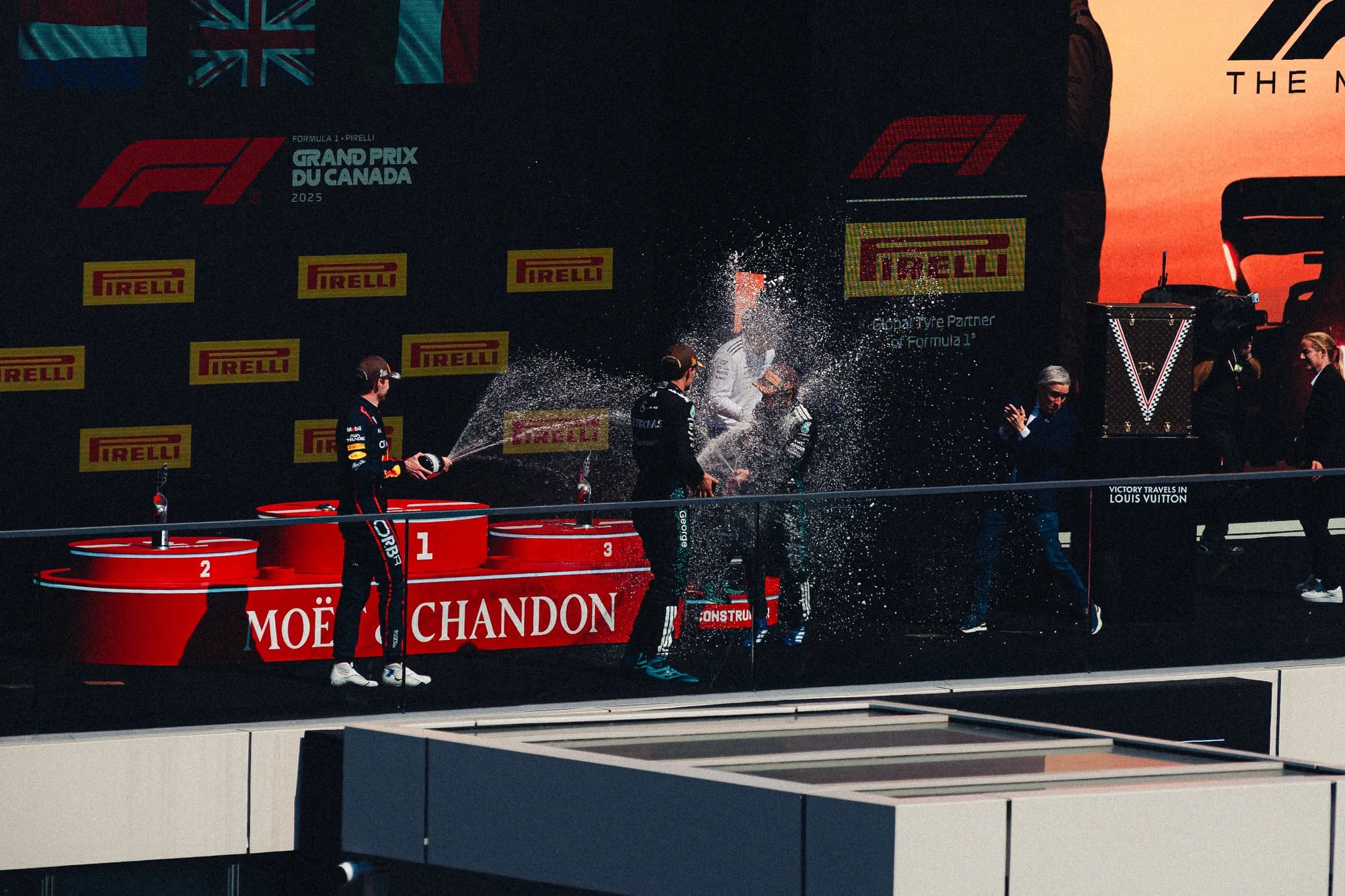 Champagne spraying over the podium at sunset