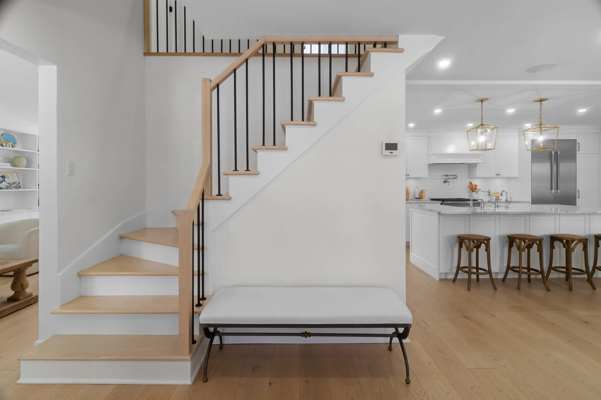 Staircase with black iron spindles beside the kitchen