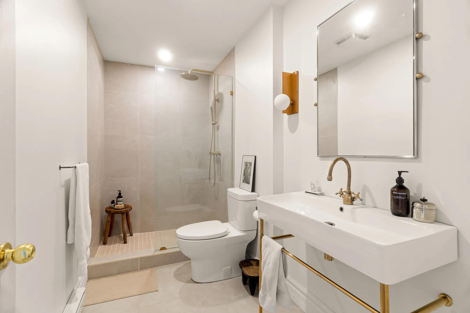 Bathroom with walk-in shower and brass accents