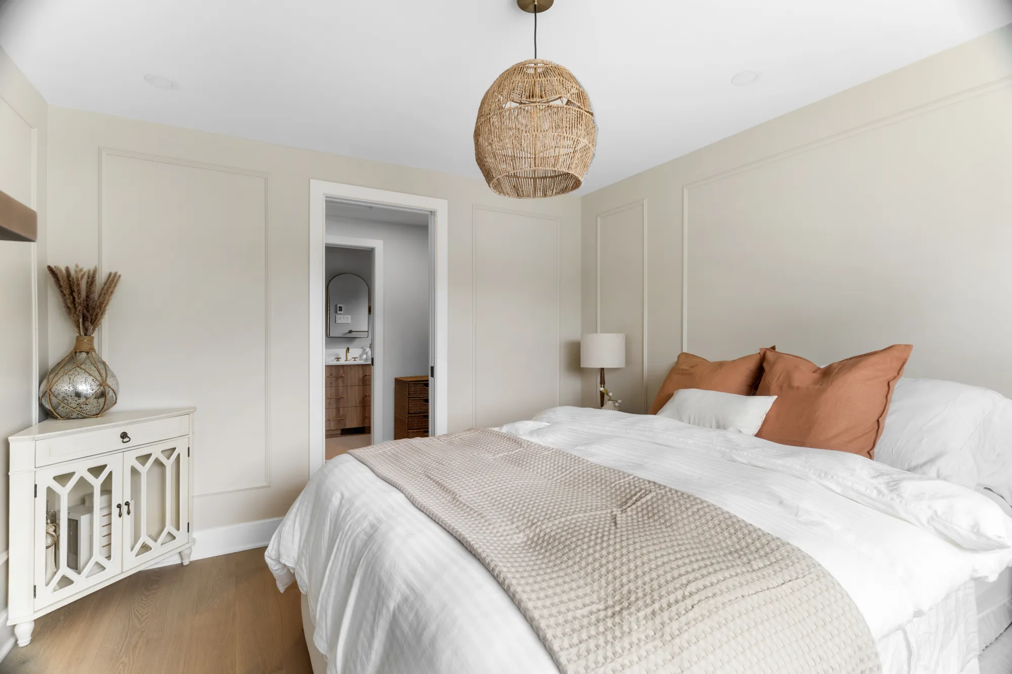 Primary bedroom dressed in warm terracotta accents
