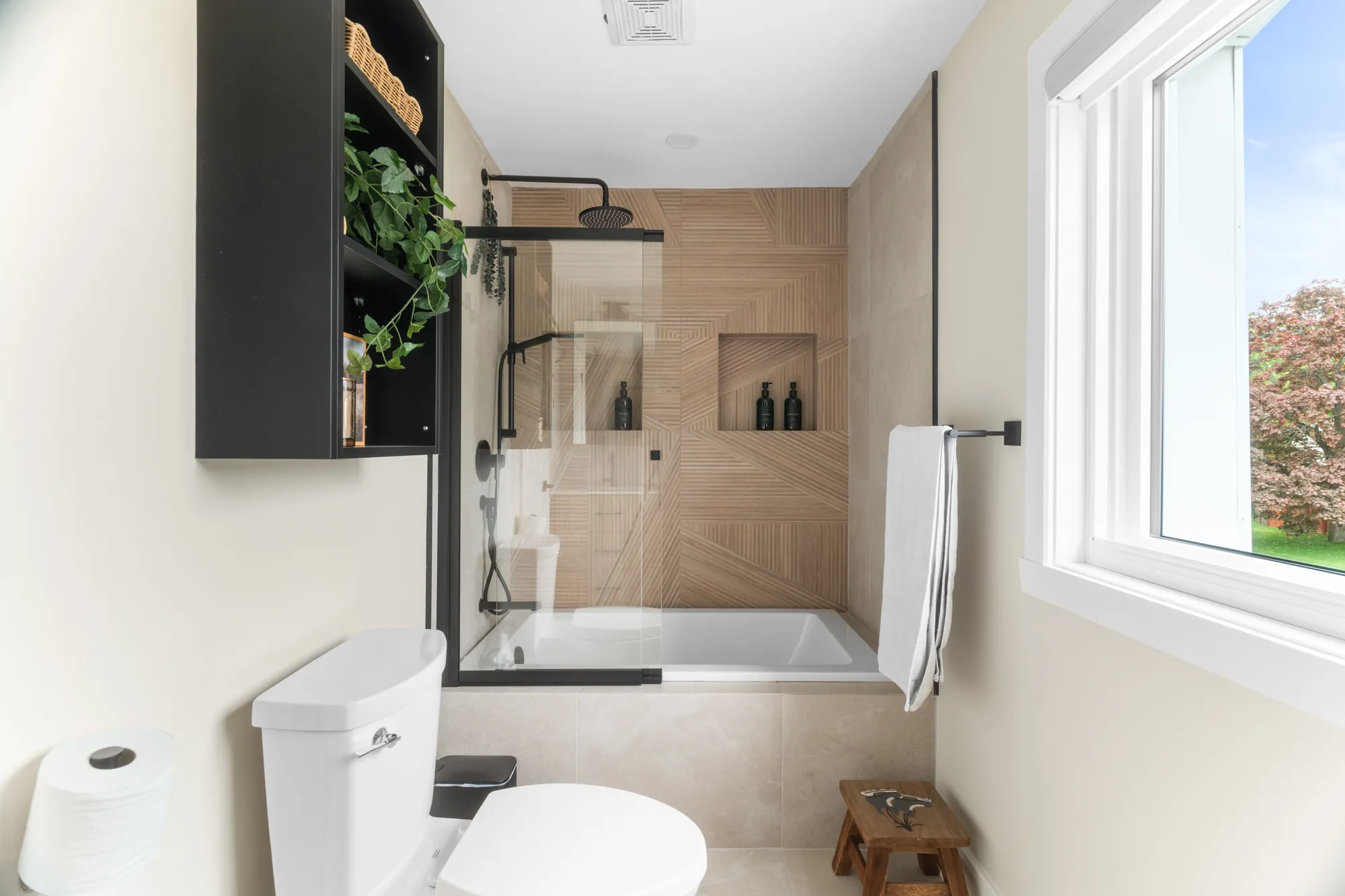 Bathroom with matte-black fixtures and a garden window